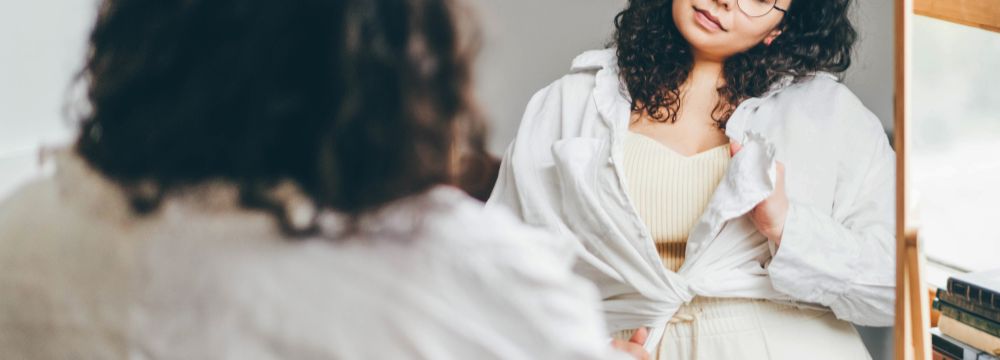 Woman looking at herself in the mirror 